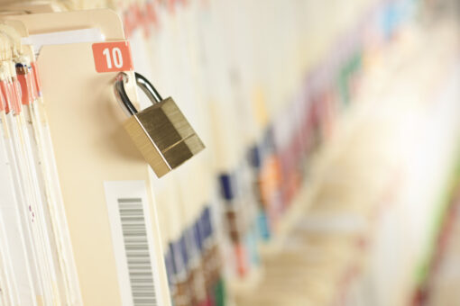 Secure and protected medical records. Bar code added to folder, not actual patient information. Concept image. Narrow depth of field.